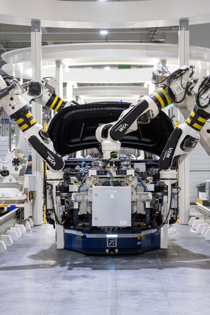 pexels-photo-19233057-19233057 High-tech robots assembling a car in a modern factory setting, showcasing automation.
